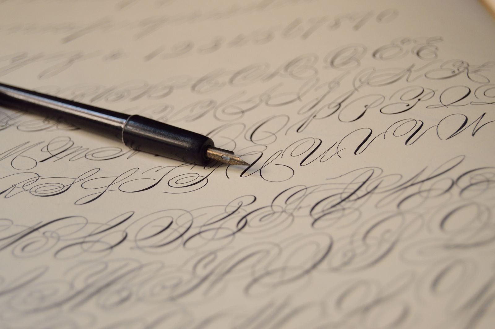 Fountain pen resting on a page of calligraphy